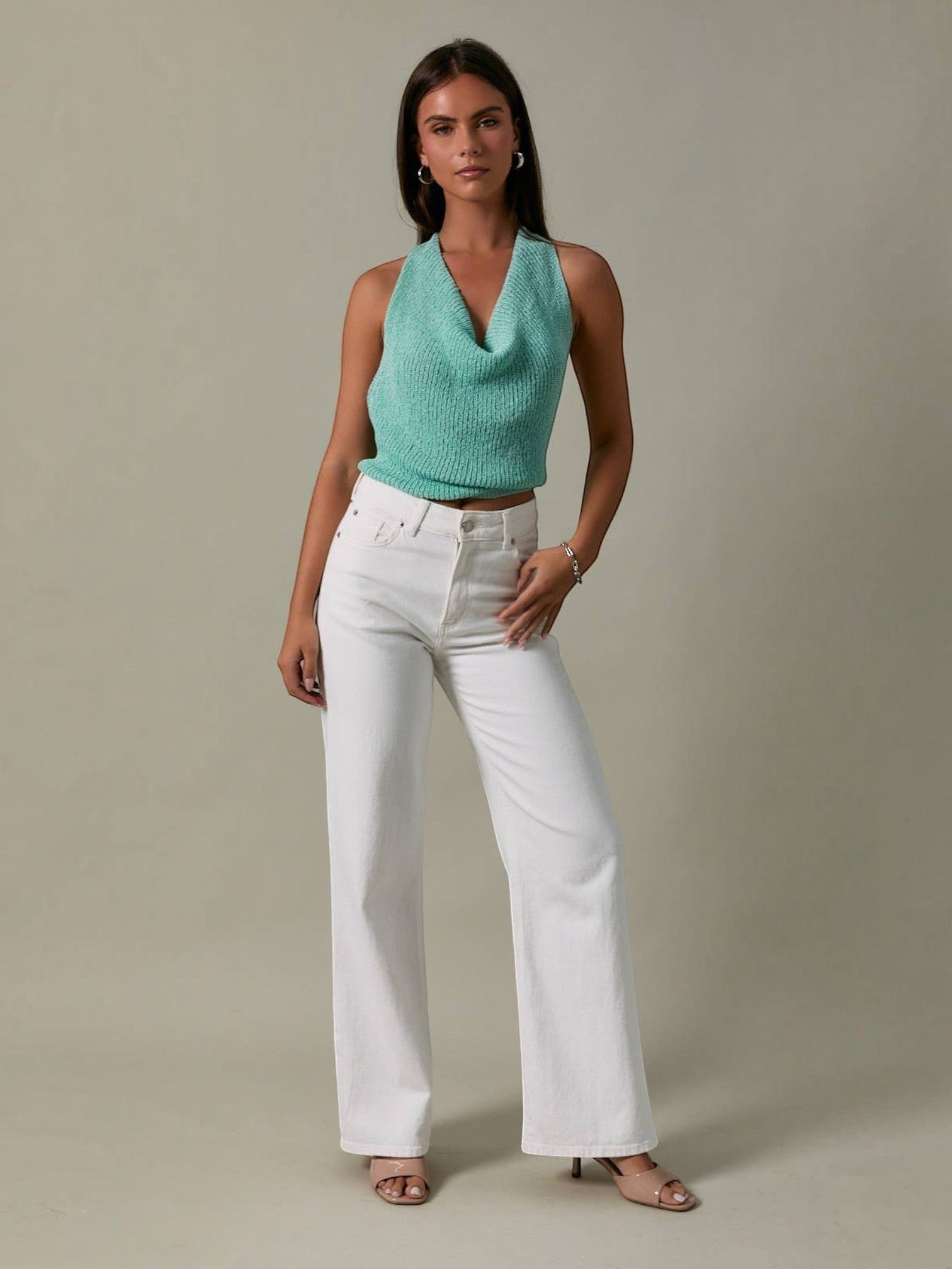 Mialur Boutique - Woman wearing a green top and white pants against a neutral background
