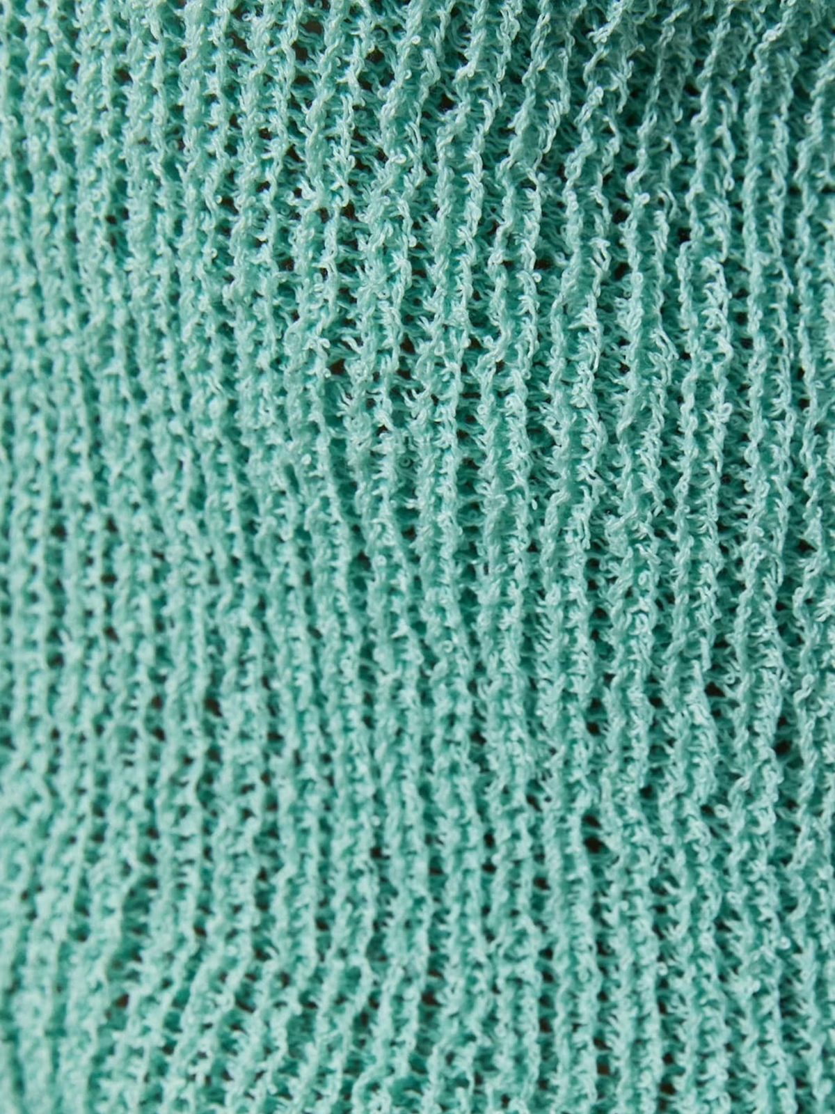 Mialur Boutique - Close-up of teal fabric with a textured pattern