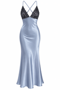 A floor-length satin slip dress in a pale icy blue color, featuring a black lace V-neckline with thin crisscrossing straps, shown against a plain white background.