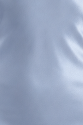 A close-up of a light blue fabric surface with soft folds and a smooth texture.