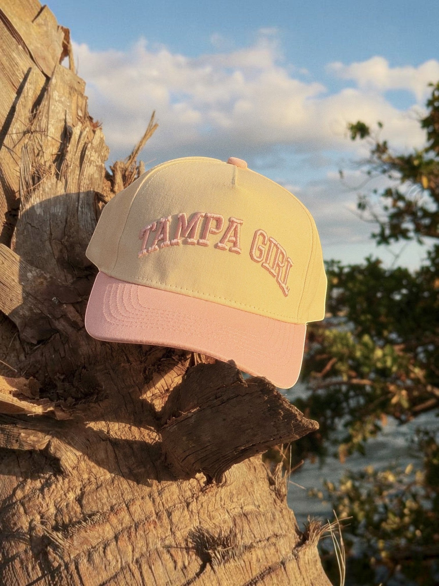 Mialur Boutique - Yellow and pink cap with 'Tampa Girl' text on a wooden surface with natural background