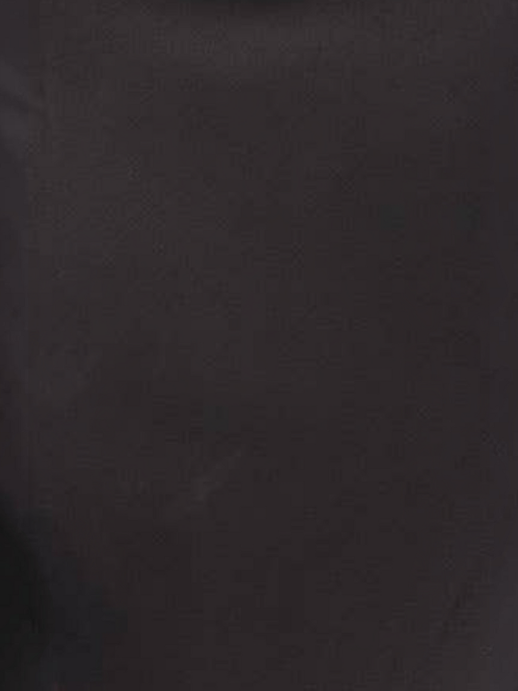 A close-up of a dark charcoal gray textured material, likely leather or suede.