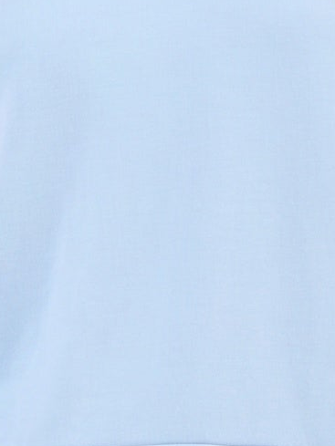 A close-up of a light blue fabric texture, likely a cotton or jersey garment material.