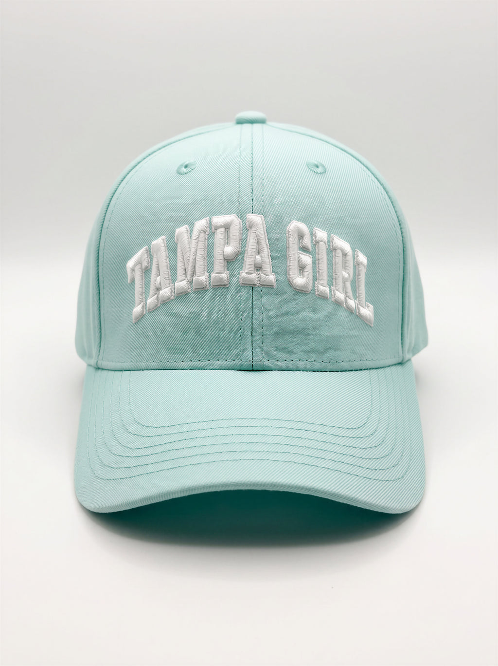 Mialur Boutique - A light mint green baseball cap with 'TAMPA GIRL' embroidered in white arched letters on the front, shown against a neutral light gray background.