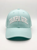Mialur Boutique - A light mint green baseball cap with 'TAMPA GIRL' embroidered in white arched letters on the front, shown against a neutral light gray background.