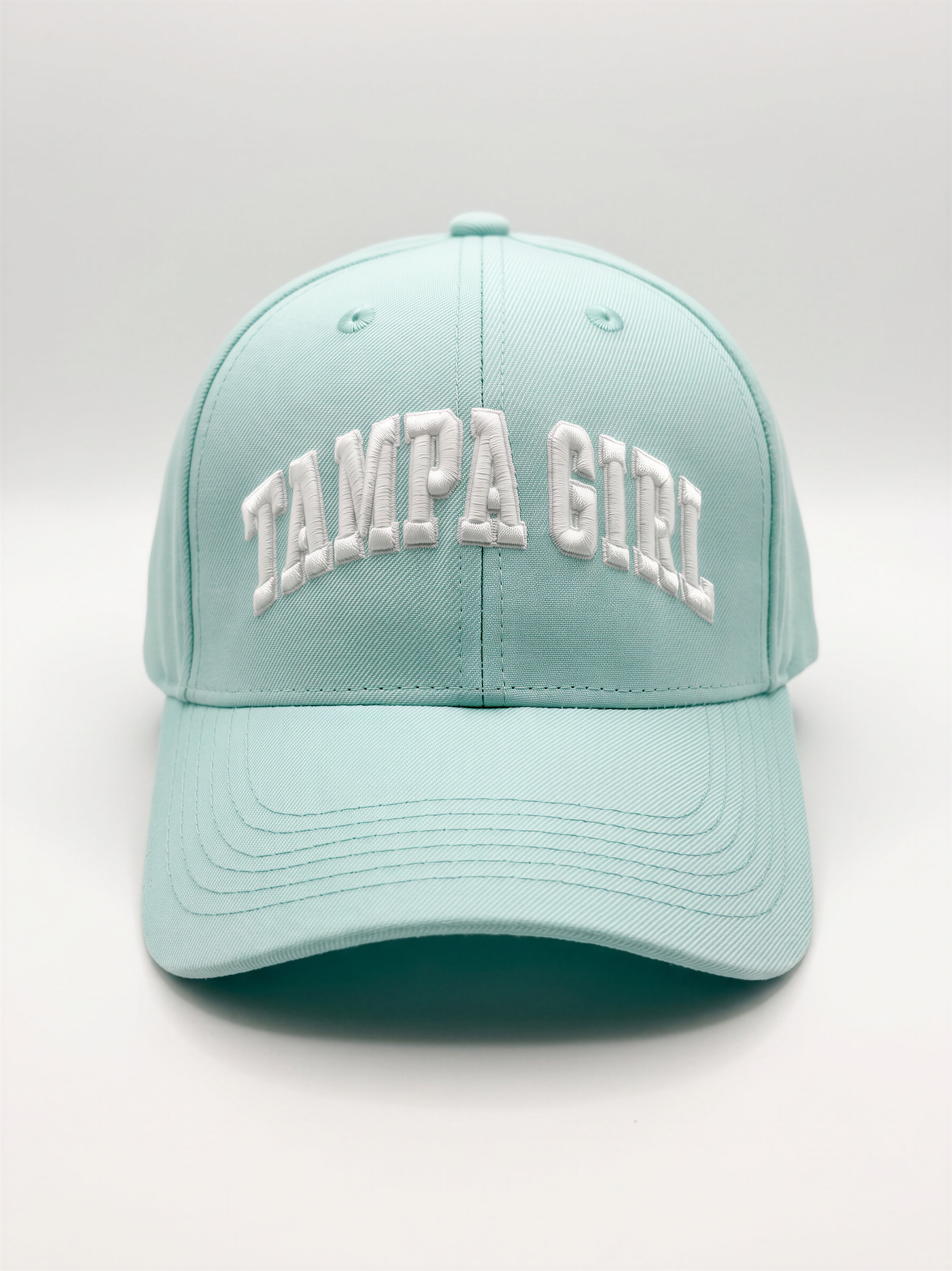 Mialur Boutique - A light mint green baseball cap with 'TAMPA GIRL' embroidered in white arched letters on the front, shown against a neutral light gray background.