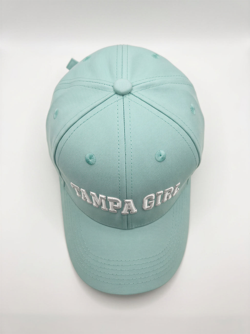 Mialur Boutique - A light mint green baseball cap with 'TAMPA GIRLS' embroidered in white across the front, photographed against a neutral light gray background.