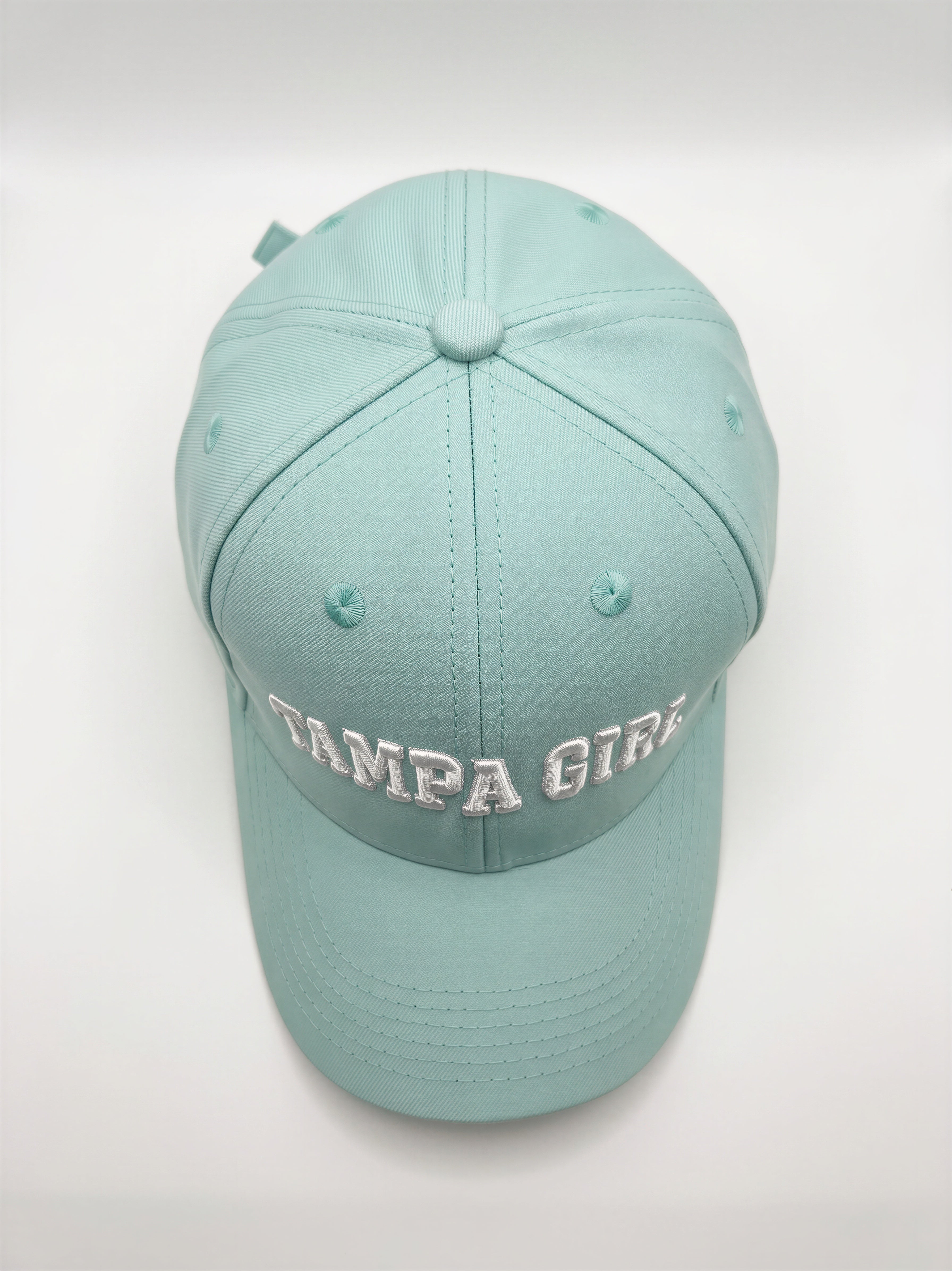 Mialur Boutique - A light mint green baseball cap with 'TAMPA GIRLS' embroidered in white across the front, photographed against a neutral light gray background.
