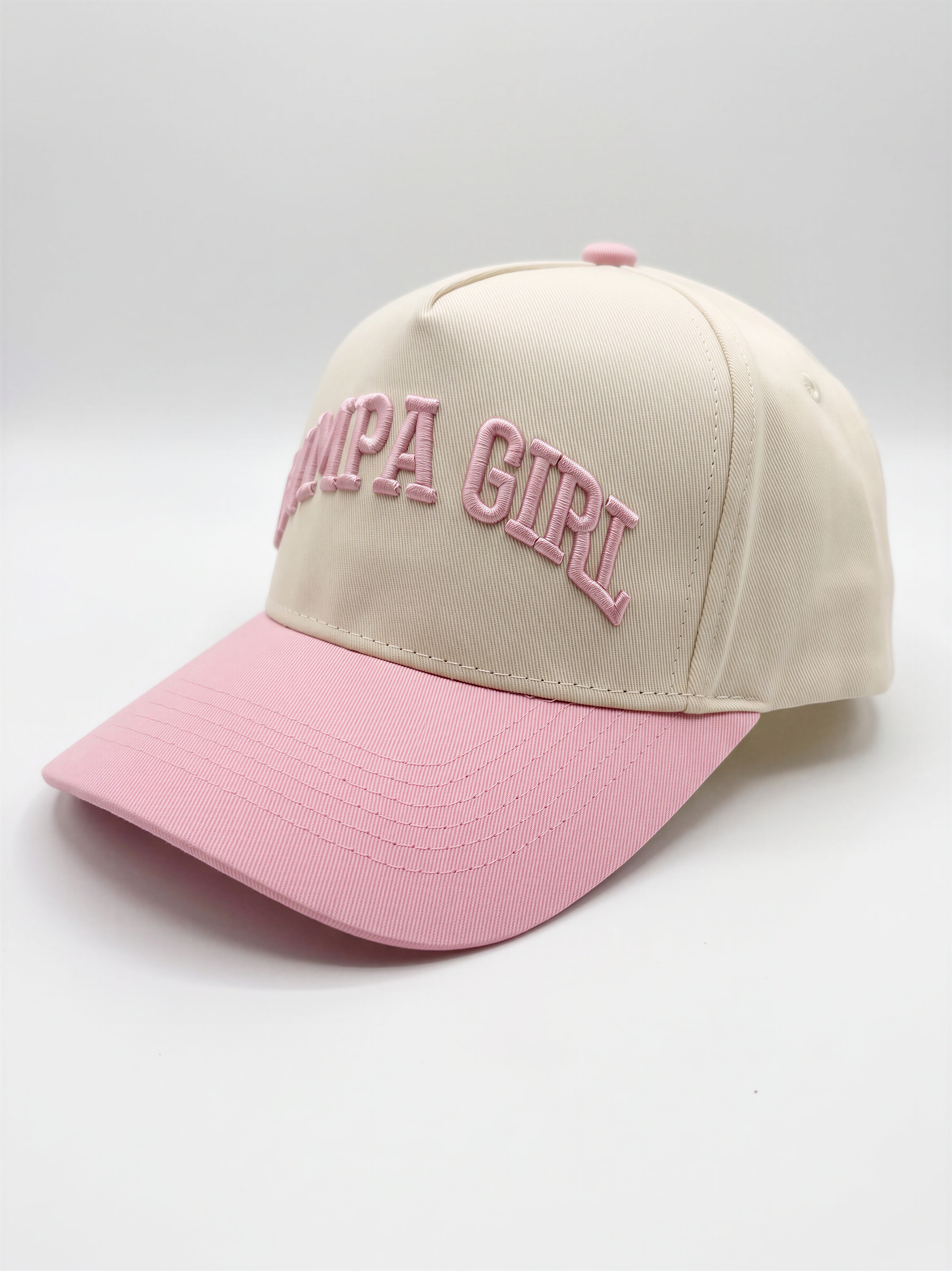 Mialur Boutique - A baseball cap with a cream-colored crown and a light pink brim, featuring the words 'Pimpa Girl' embroidered in pink on the front.