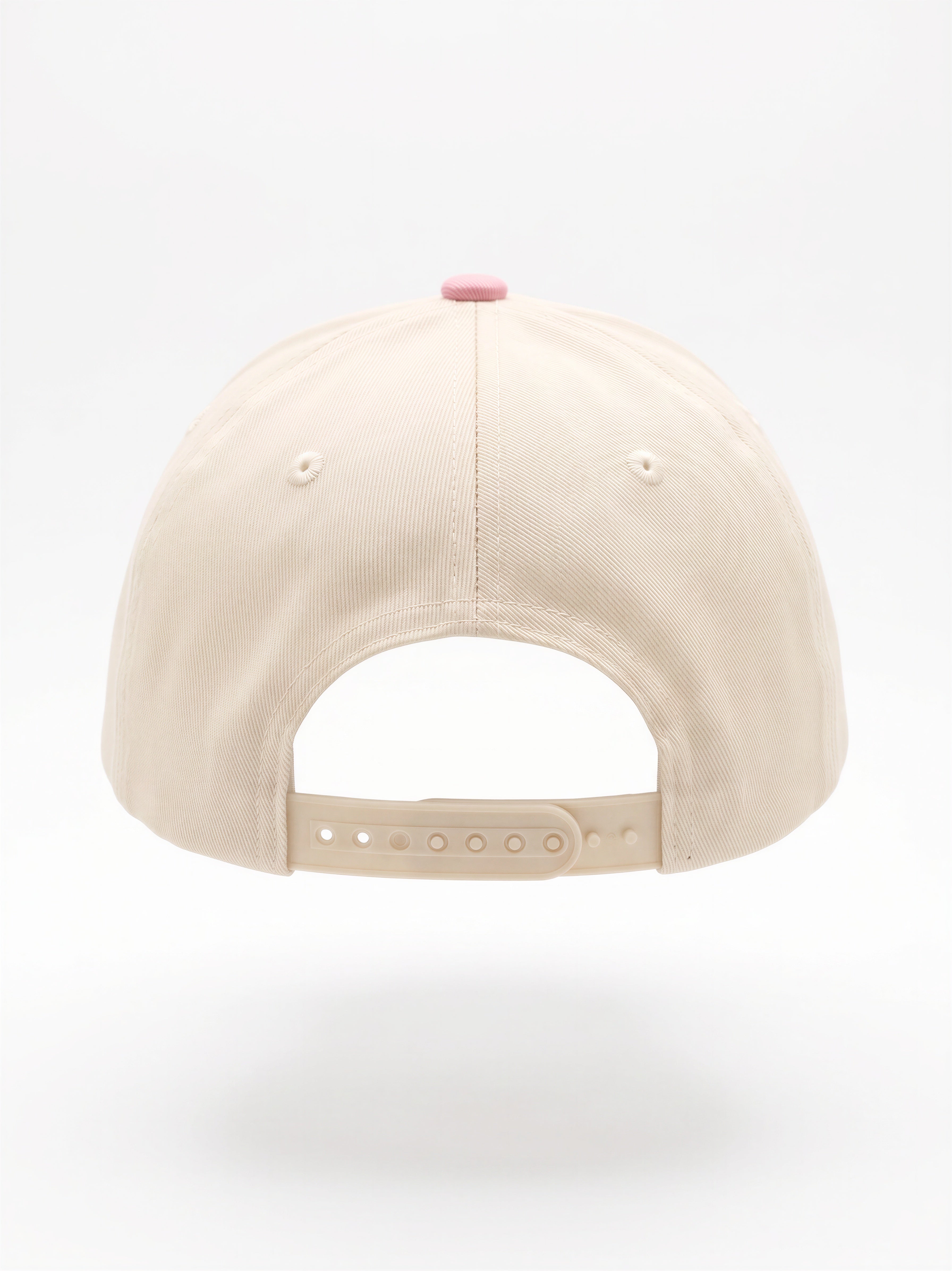 Mialur Boutique - The back view of a beige baseball cap with an adjustable strap and a small pink button on top, shown against a plain white background.