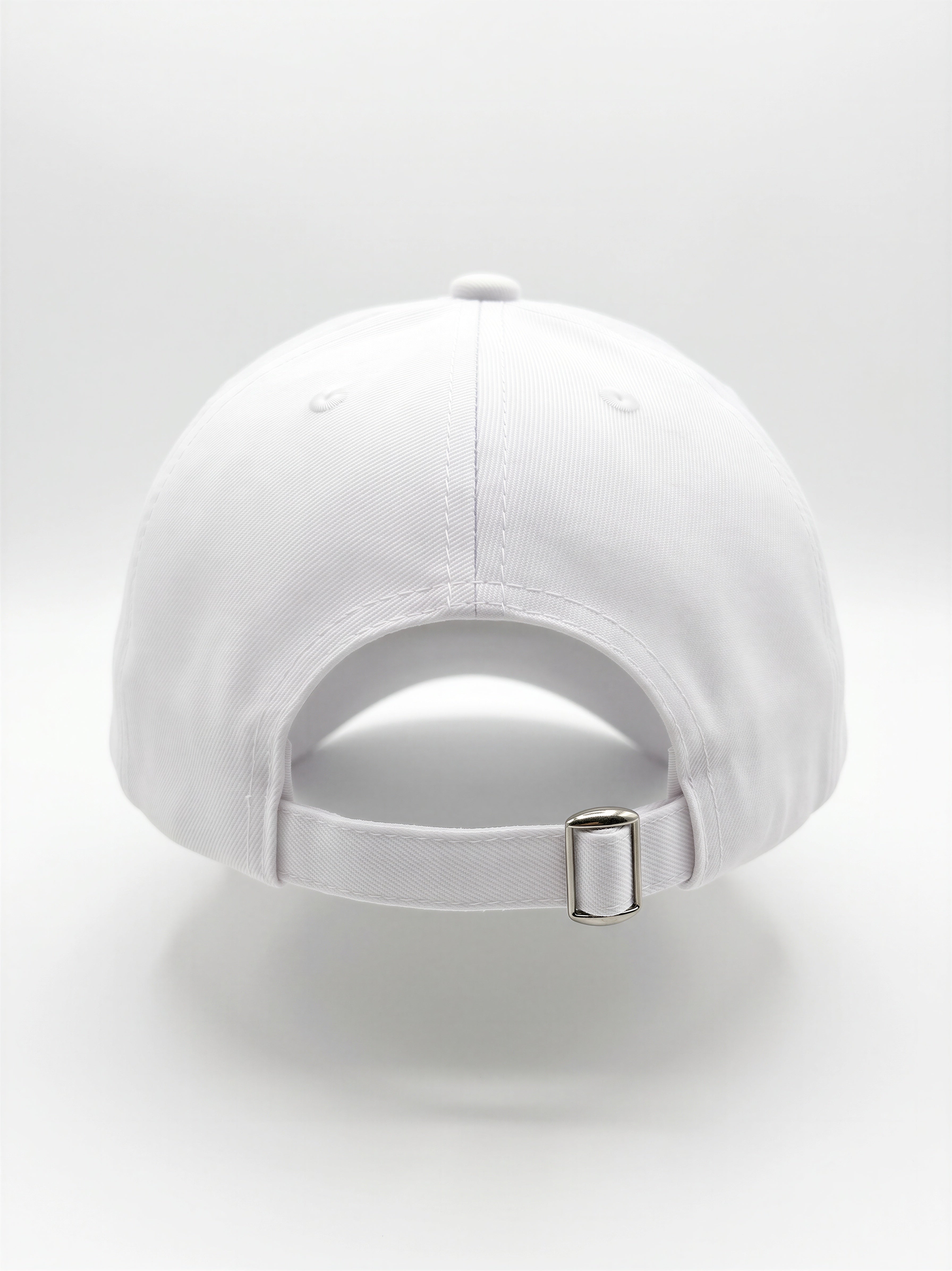 Mialur Boutique - White baseball cap shown from the back, featuring a curved crown, an adjustable fabric strap, and a silver metal buckle, set against a seamless white studio background.