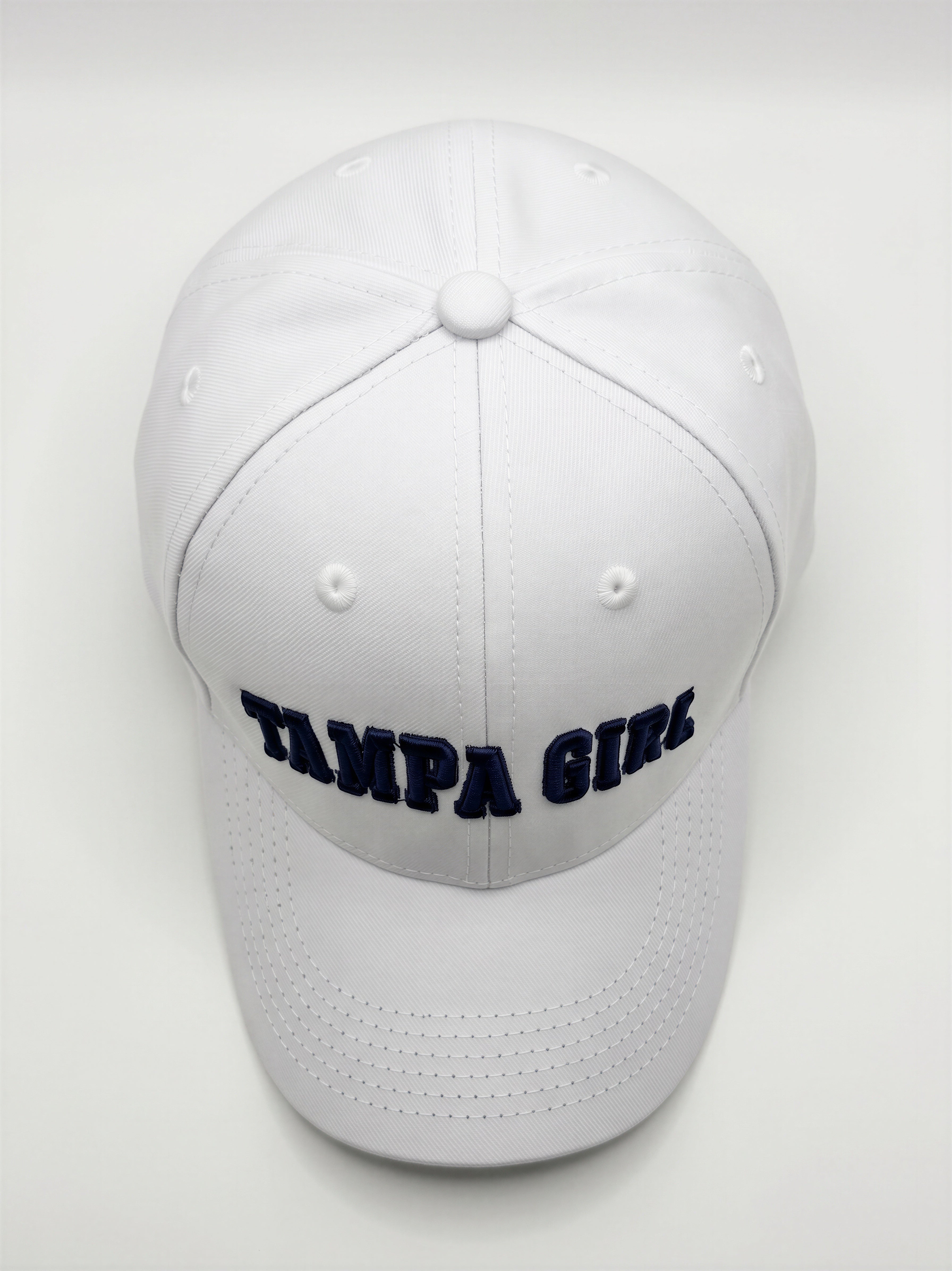 Mialur Boutique - A white structured baseball cap with 'TAMPA GIRLS' embroidered in navy blue across the front, photographed against a light gray background.