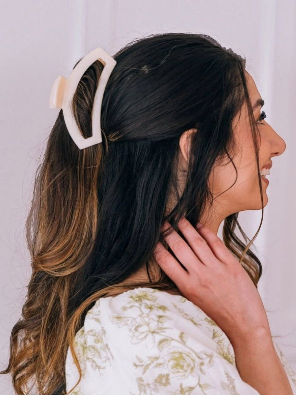 Mialur almond beige medium open claw hair clip worn in a half-up hairstyle by a woman with long dark wavy hair