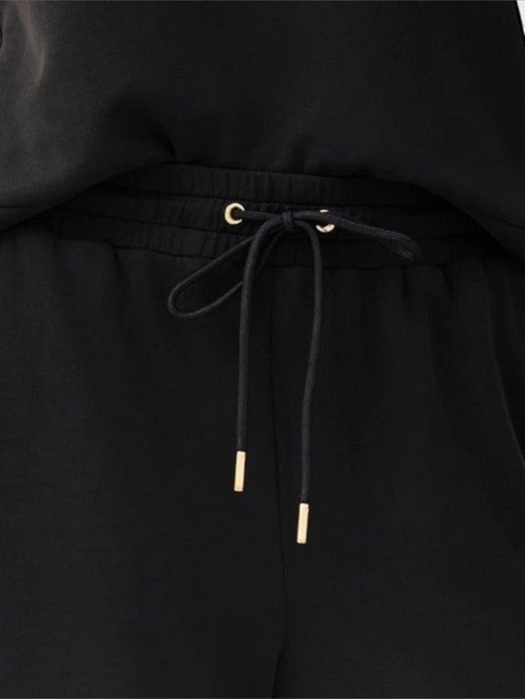 Mialur Avery black cropped wide-leg pants featuring an adjustable drawstring waistband with gold-toned metal tips.