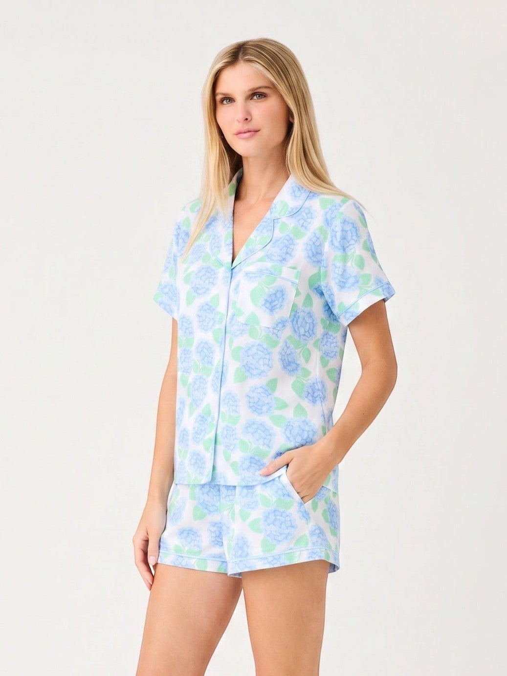 A model wearing the Mialur Azure Bloom satin lounge set with a blue floral print, button-front top, and shorts.