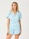 Model wearing Mialur Azure Bloom satin lounge set with blue floral print, button-front top, and drawstring shorts.