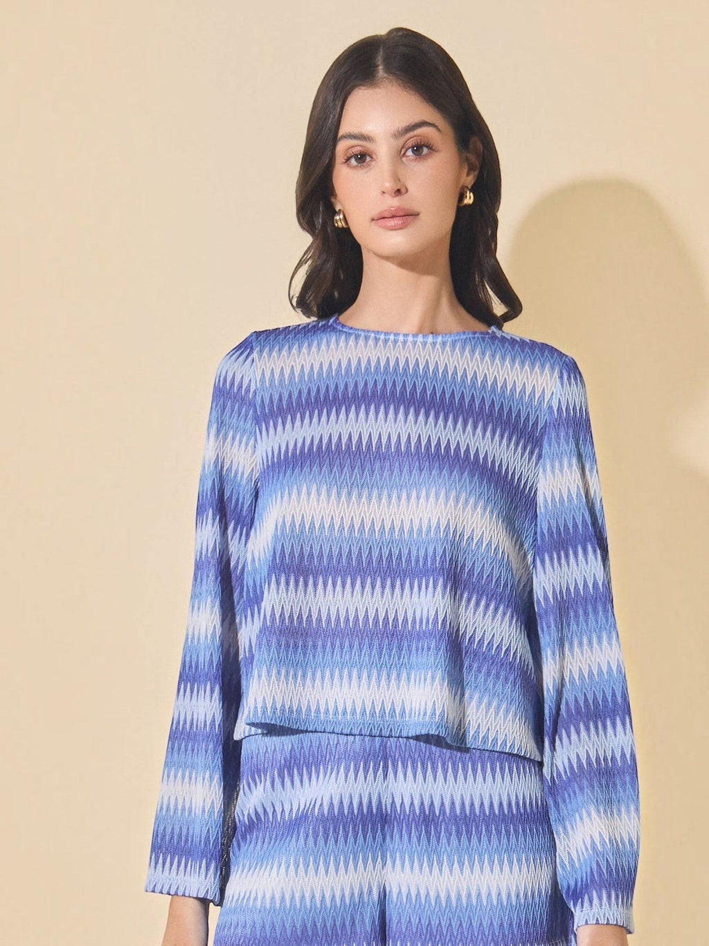 Mialur Azure Waves sweater with blue and white wave-patterned stripes, round neckline, and long bell sleeves.