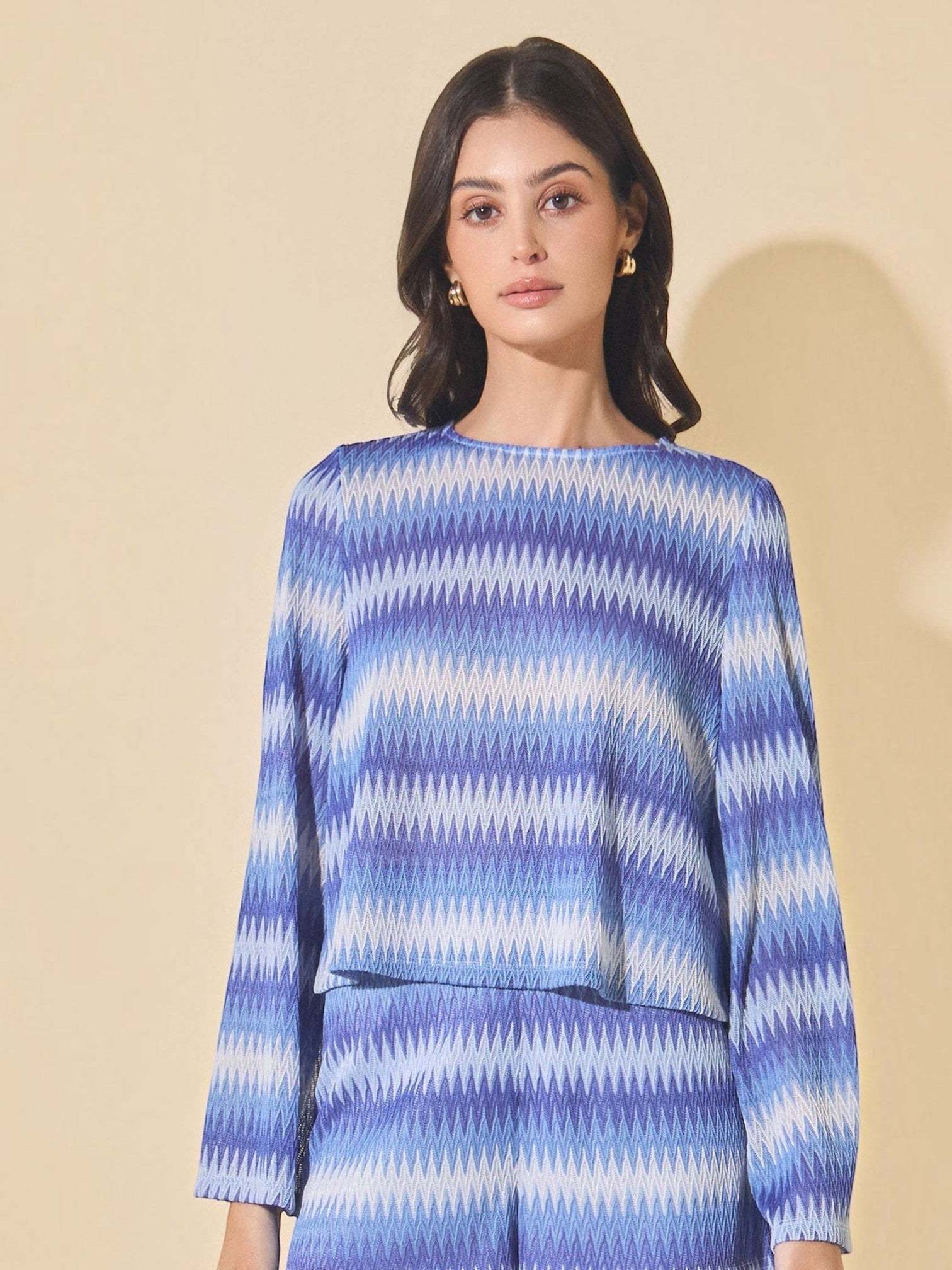 Mialur Azure Waves sweater with blue and white wave-patterned stripes, round neckline, and long bell sleeves.
