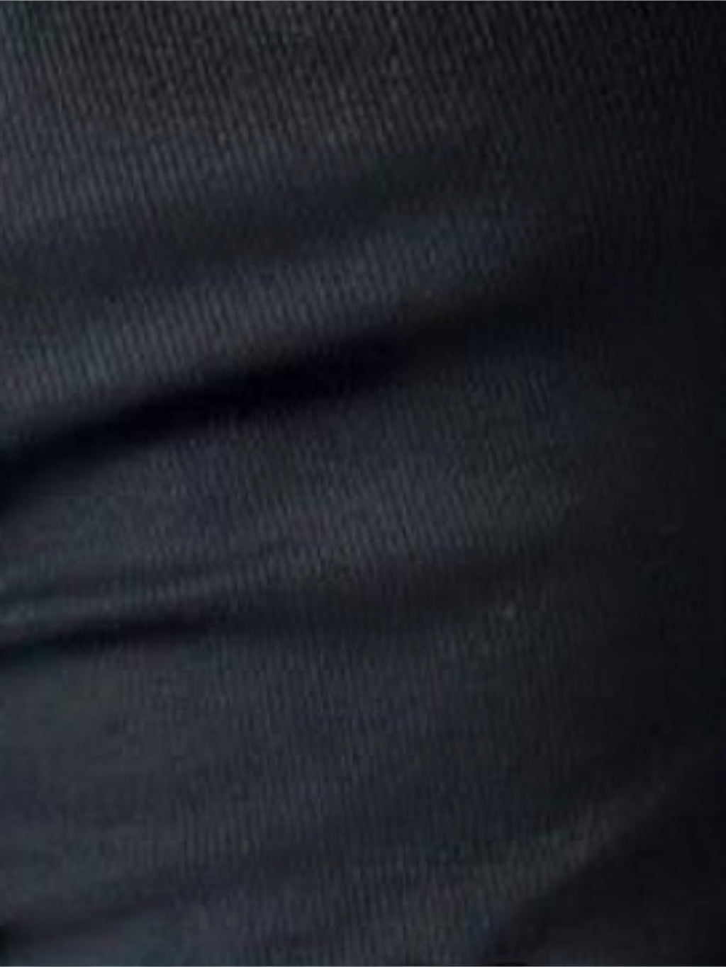 Close-up of the soft black ribbed fabric of a Mialur one-shoulder long sleeve top.