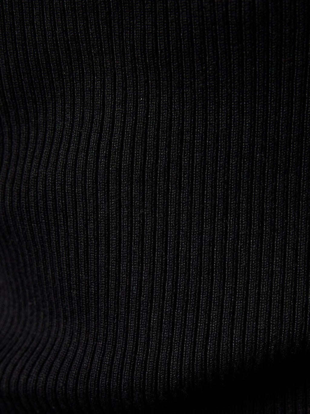 Close-up of the Mialur black ribbed fabric texture on the Essential Halter Top, showing soft vertical knit details.