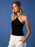 Model wearing a Mialur black ribbed halter top with a fitted silhouette against a blue background