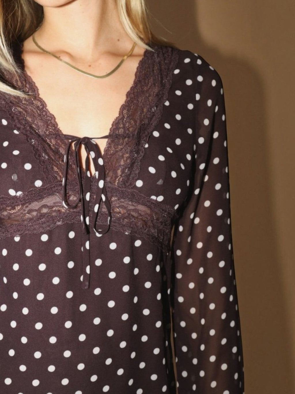 Mialur brown polka dot mini dress featuring sheer long sleeves, delicate lace trim, and a feminine tie-front neckline.