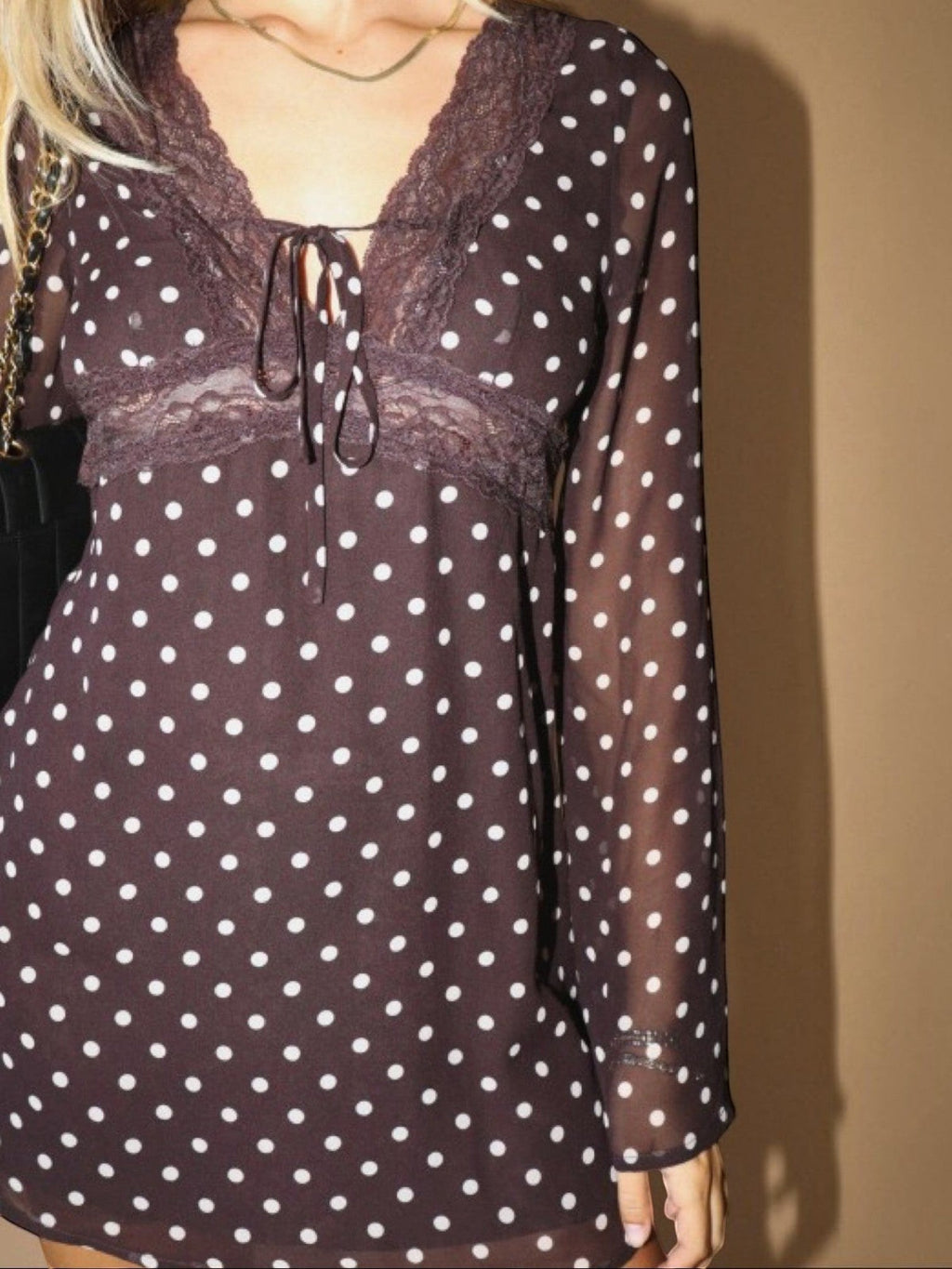 Mialur brown mini dress with white polka dots, sheer long sleeves, and delicate lace trim on the bodice.