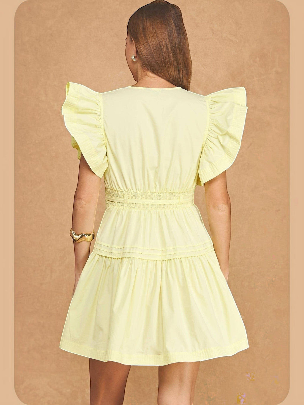 Back view of Mialur butter yellow babydoll midi dress with flutter sleeves and a smocked waist on a model