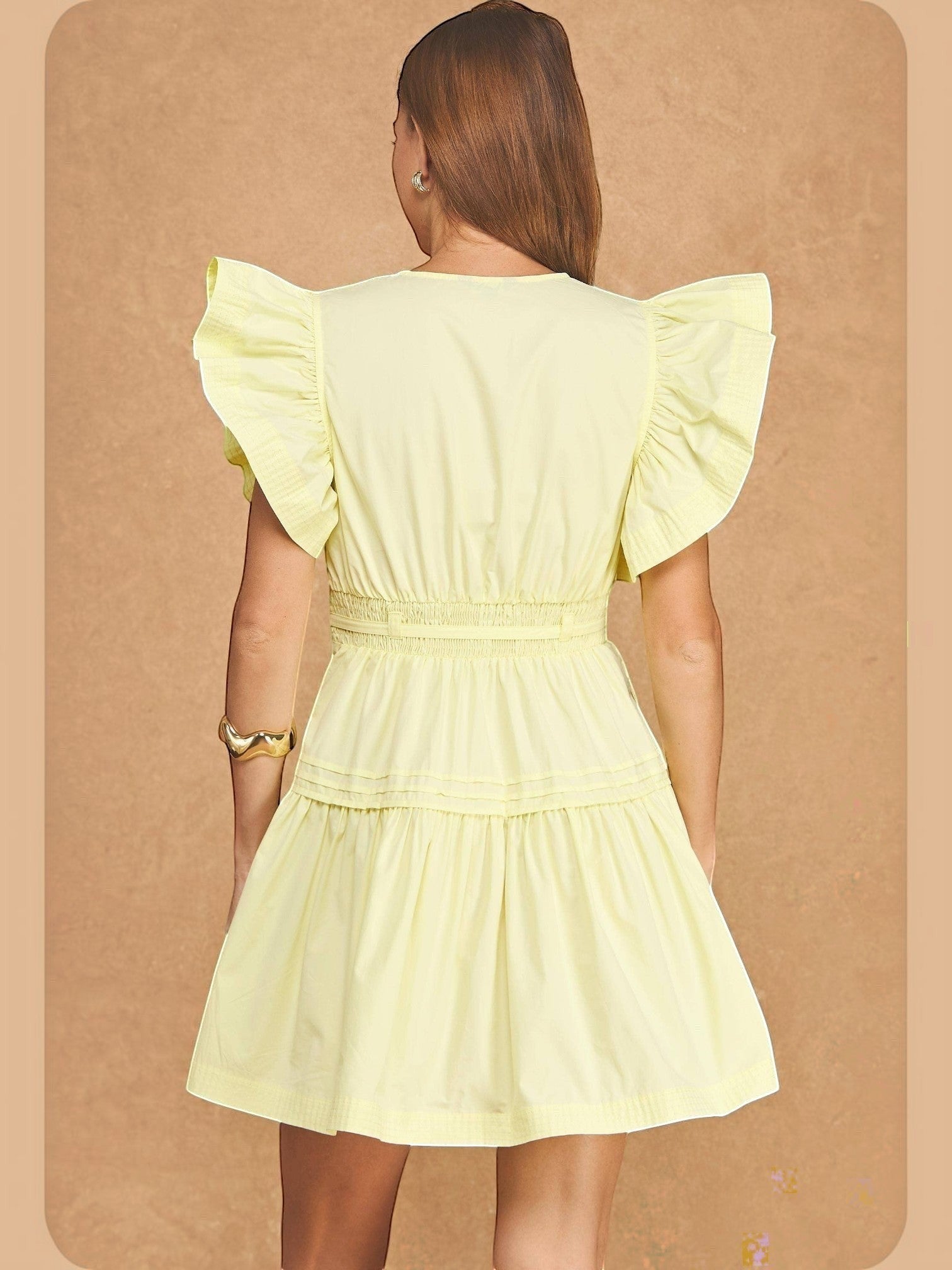 Back view of Mialur butter yellow babydoll midi dress with flutter sleeves and a smocked waist on a model