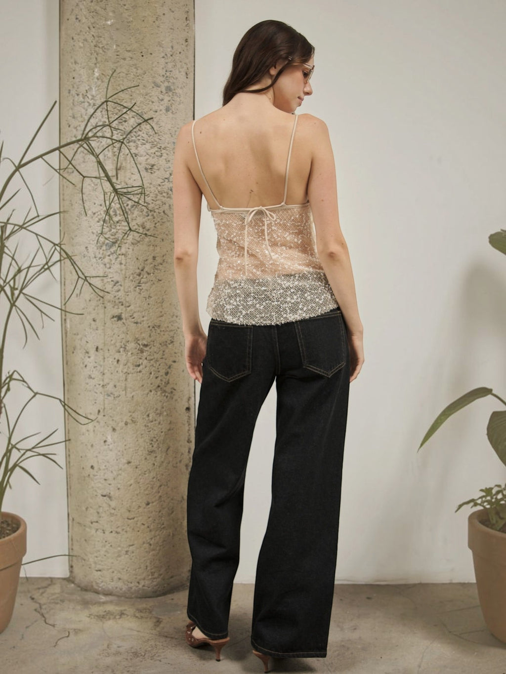 Mialur Celeste Cami in sheer beaded mesh with pearl-inspired details, worn by a model with dark denim jeans