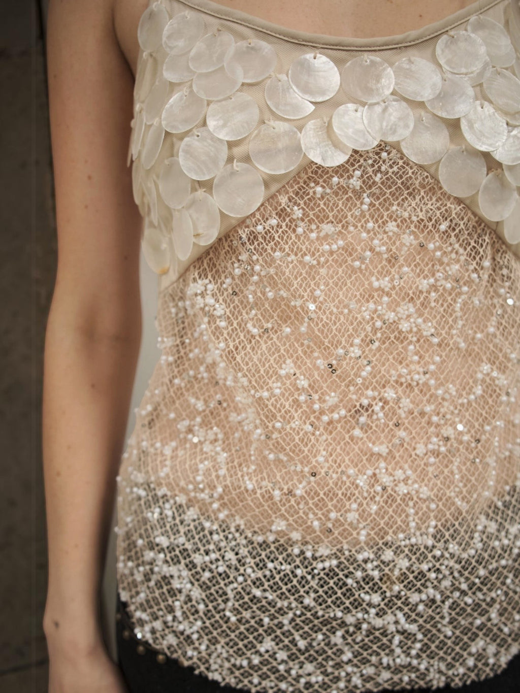 Mialur Celeste Cami featuring sheer mesh fabric with pearl-inspired discs and delicate beadwork on a sleeveless top.