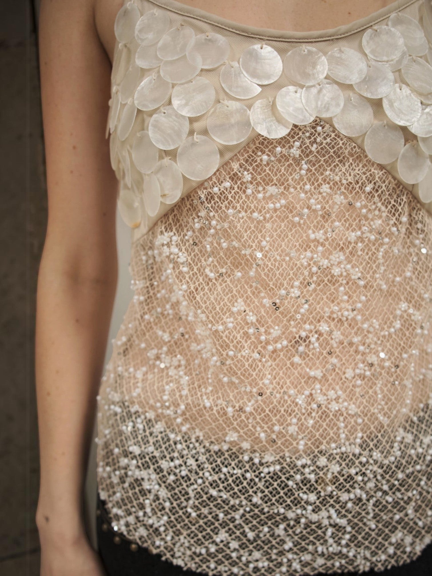 Mialur Celeste Cami featuring sheer mesh fabric with pearl-inspired discs and delicate beadwork on a sleeveless top.
