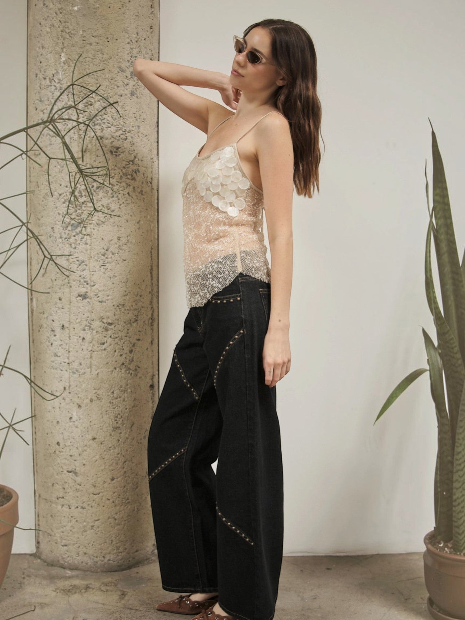 Mialur Celeste Cami featuring sheer beaded mesh and oversized pearl-inspired details worn with black wide-leg jeans.