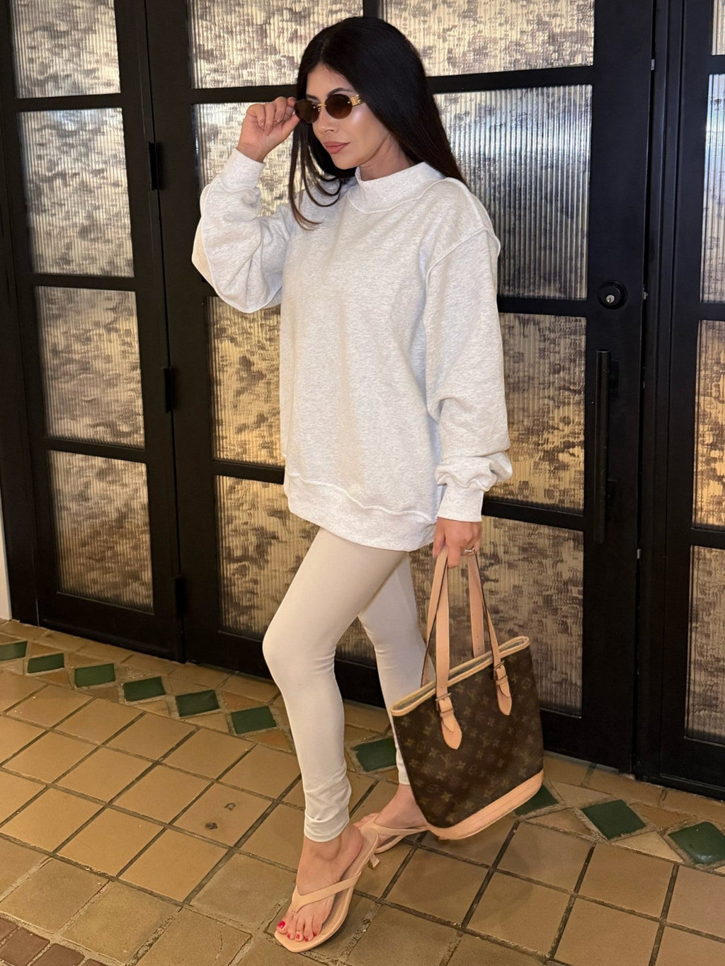 Mialur Cool Mom mock neck sweatshirt in light grey worn by a woman with leggings and a designer tote bag