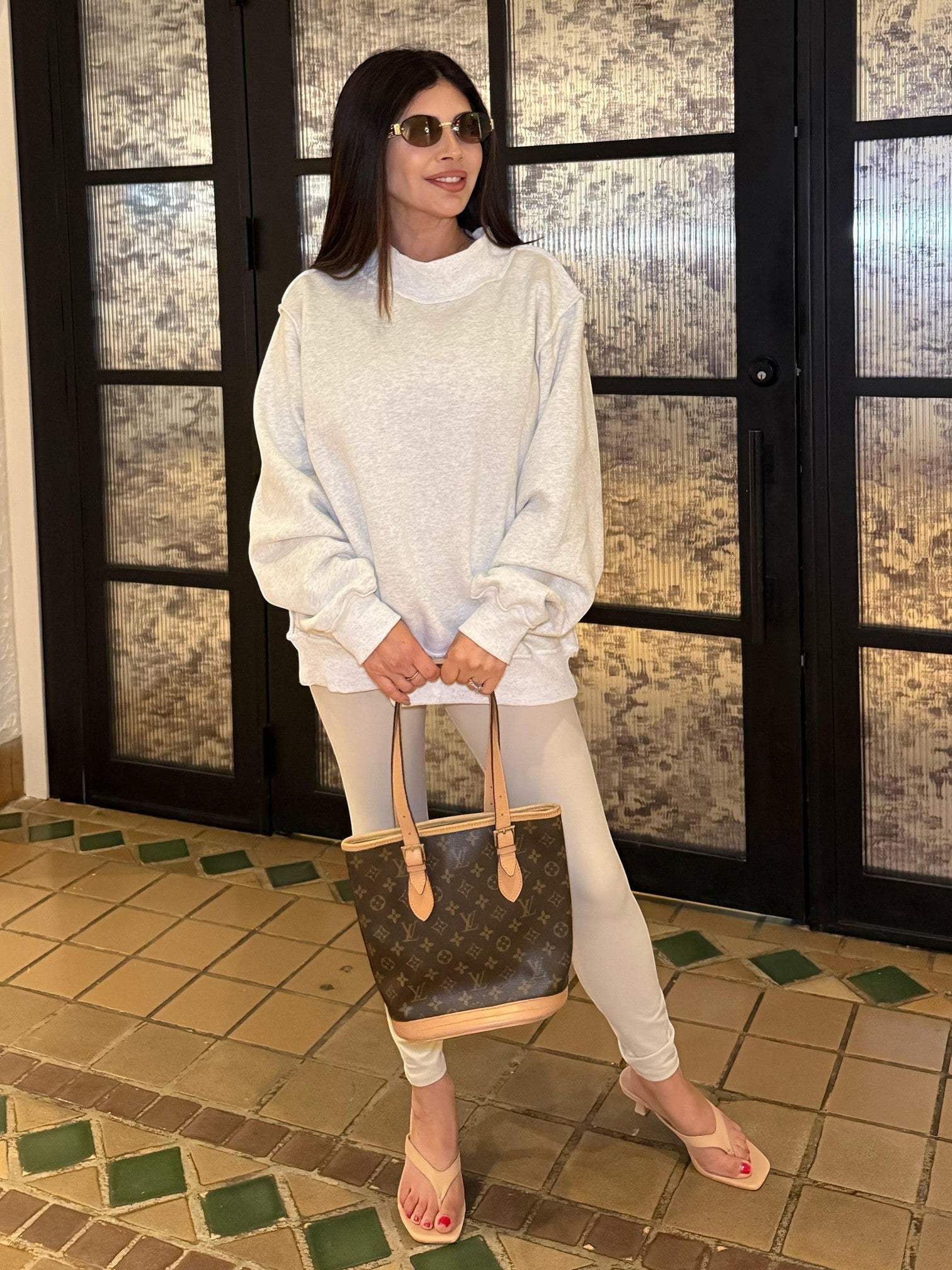 Mialur Cool Mom mock neck reversible sweatshirt in light grey worn by a woman with sunglasses and a designer bag.