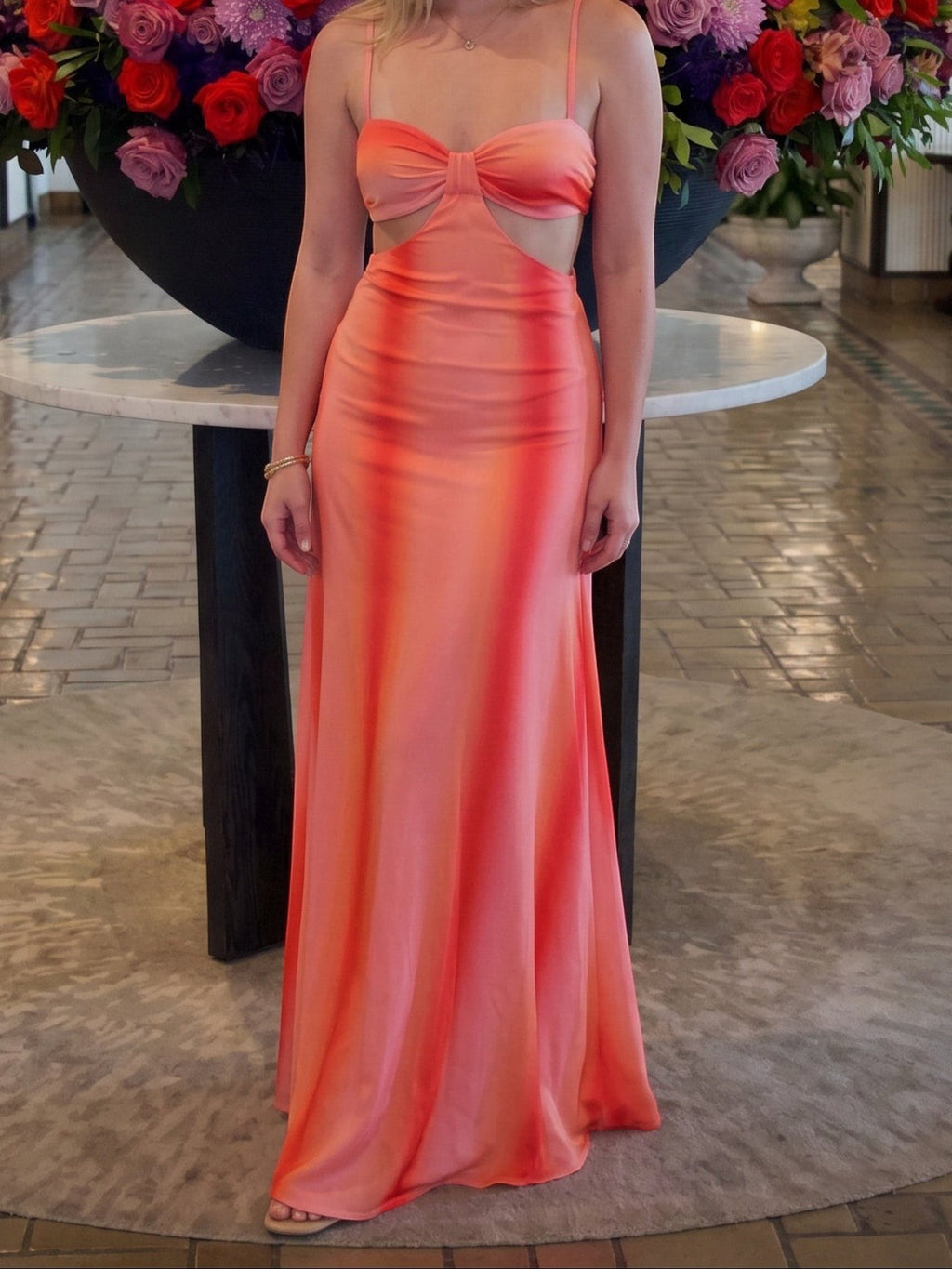 Mialur Sunset Escape coral pink maxi dress with ruched bust, waist cutouts, and center hardware detail.