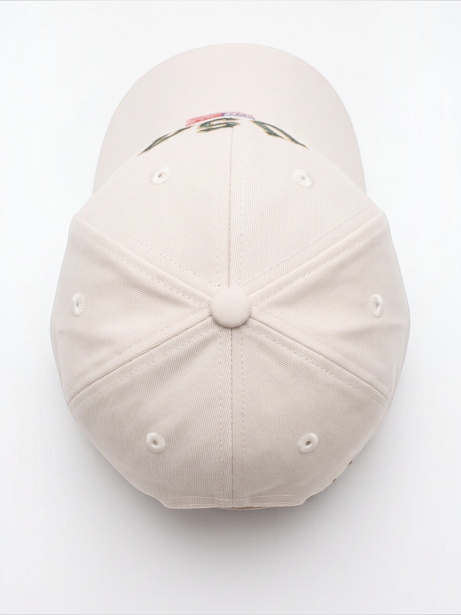 Top view of a cream Mialur baseball hat with embroidered USA lettering and an American flag detail on the curved brim.