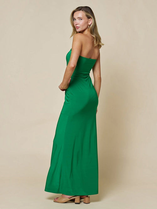 Model wearing Mialur emerald green strapless bodycon maxi dress with gold hardware detail, side view