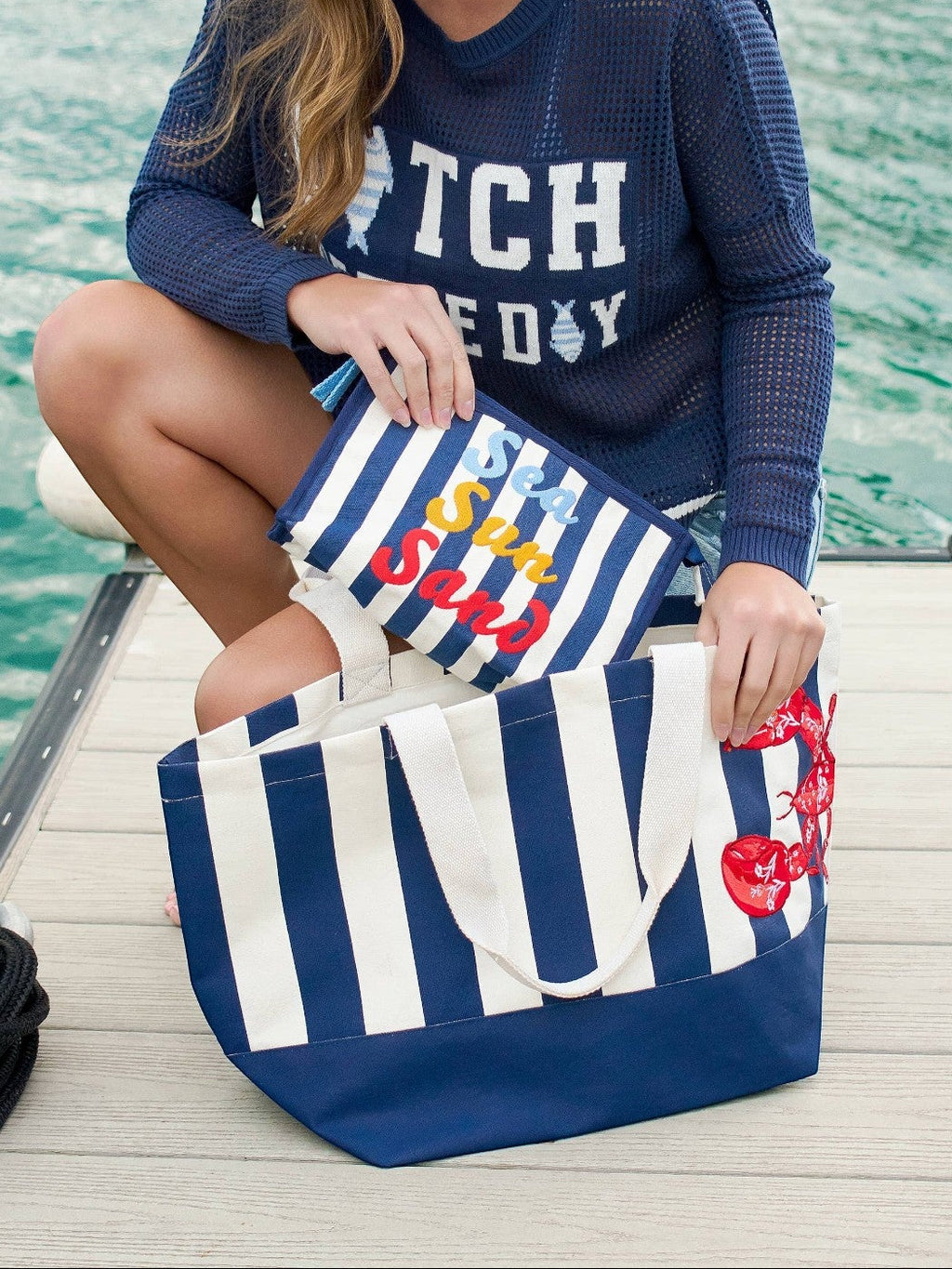 Mialur Endless Summer zip pouch with navy and white stripes and colorful embroidered lettering on a dock.