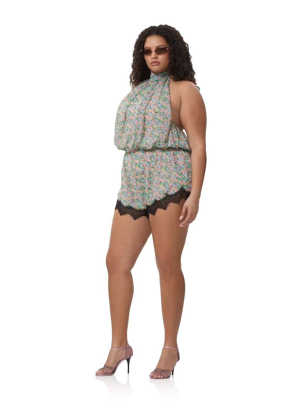 Mialur Fleur floral romper with high neckline, relaxed fit, and black lace trim worn by a model with heels