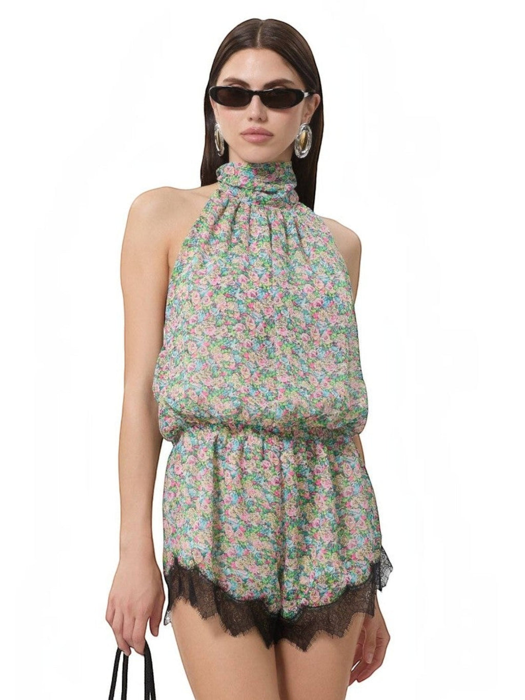Model wearing Mialur Fleur floral print romper with high neckline and black lace trim at the hem