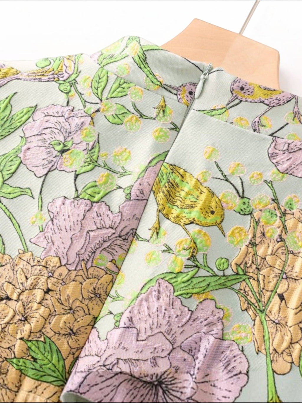 Mialur Flora mini dress in sage green with lavender and golden botanical floral and bird print on a mock neck design