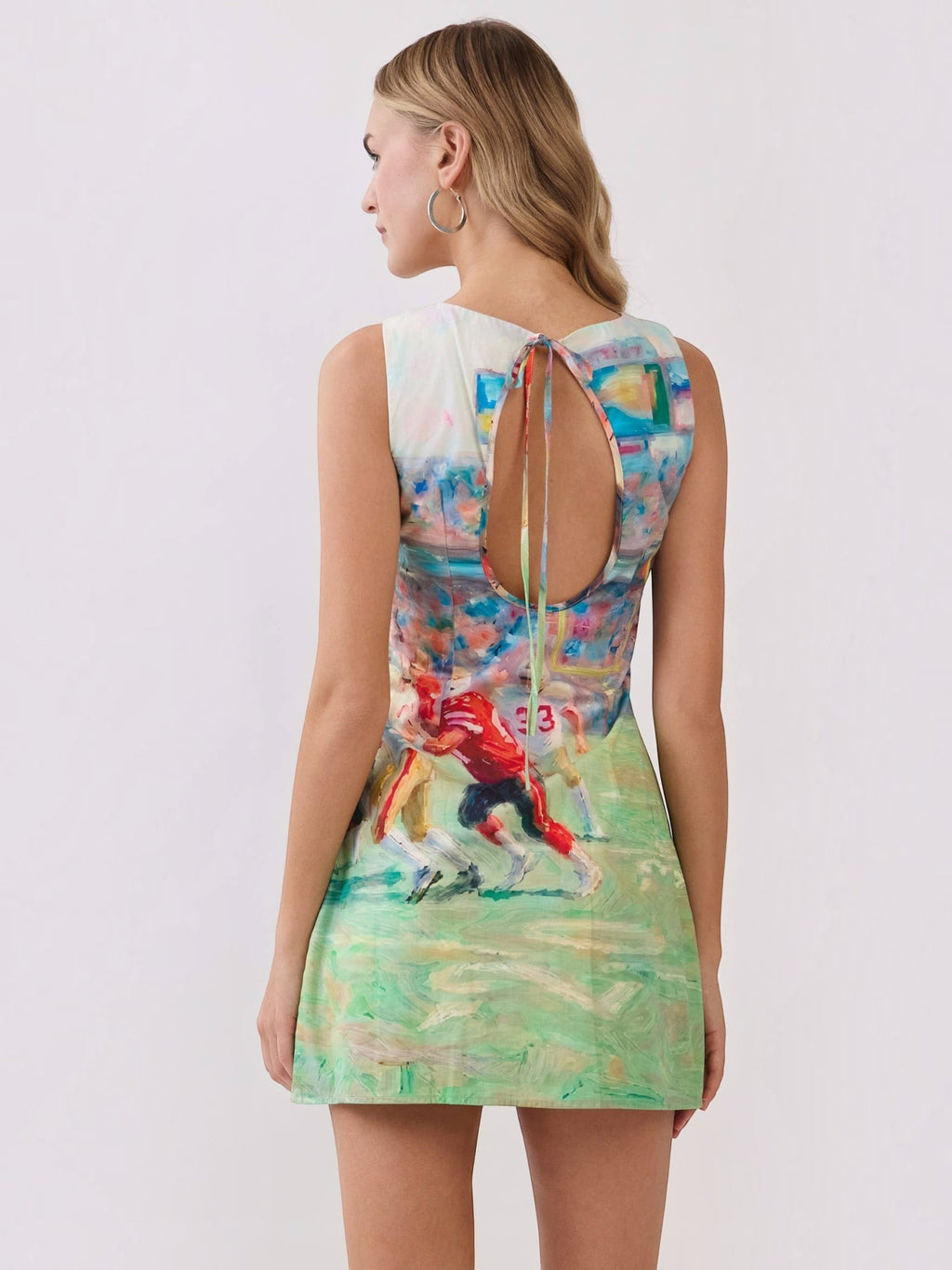 Mialur mini dress with abstract football game print, featuring a round neckline and an open-back keyhole with tie detail.