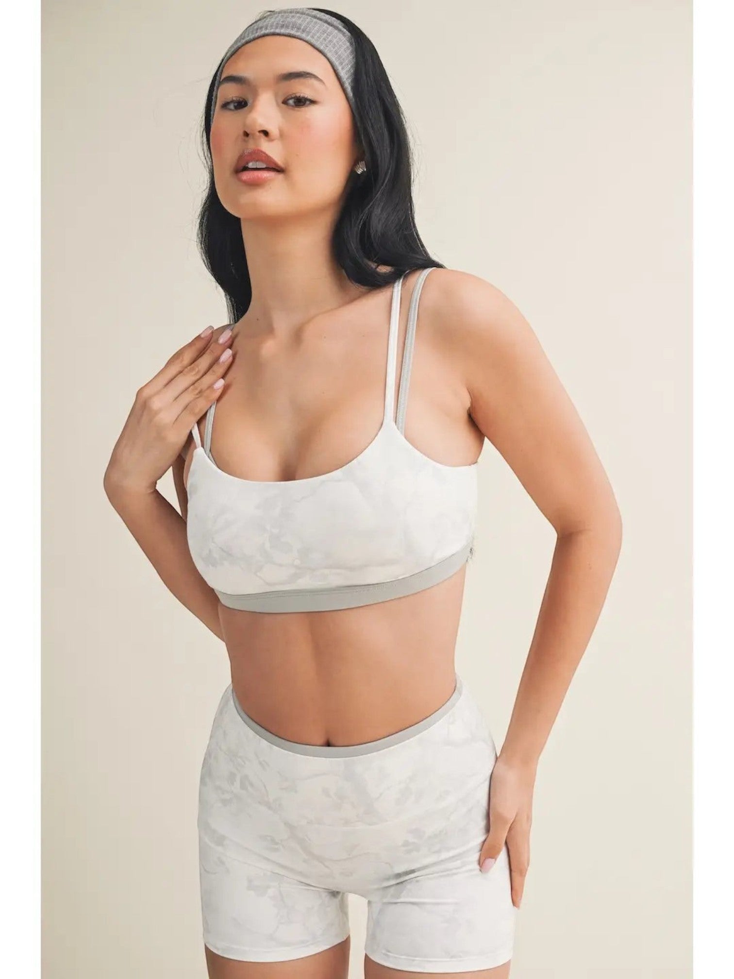 Mialur gray and white camo print double-layered sports bra with a built-in shelf bra worn by a model.