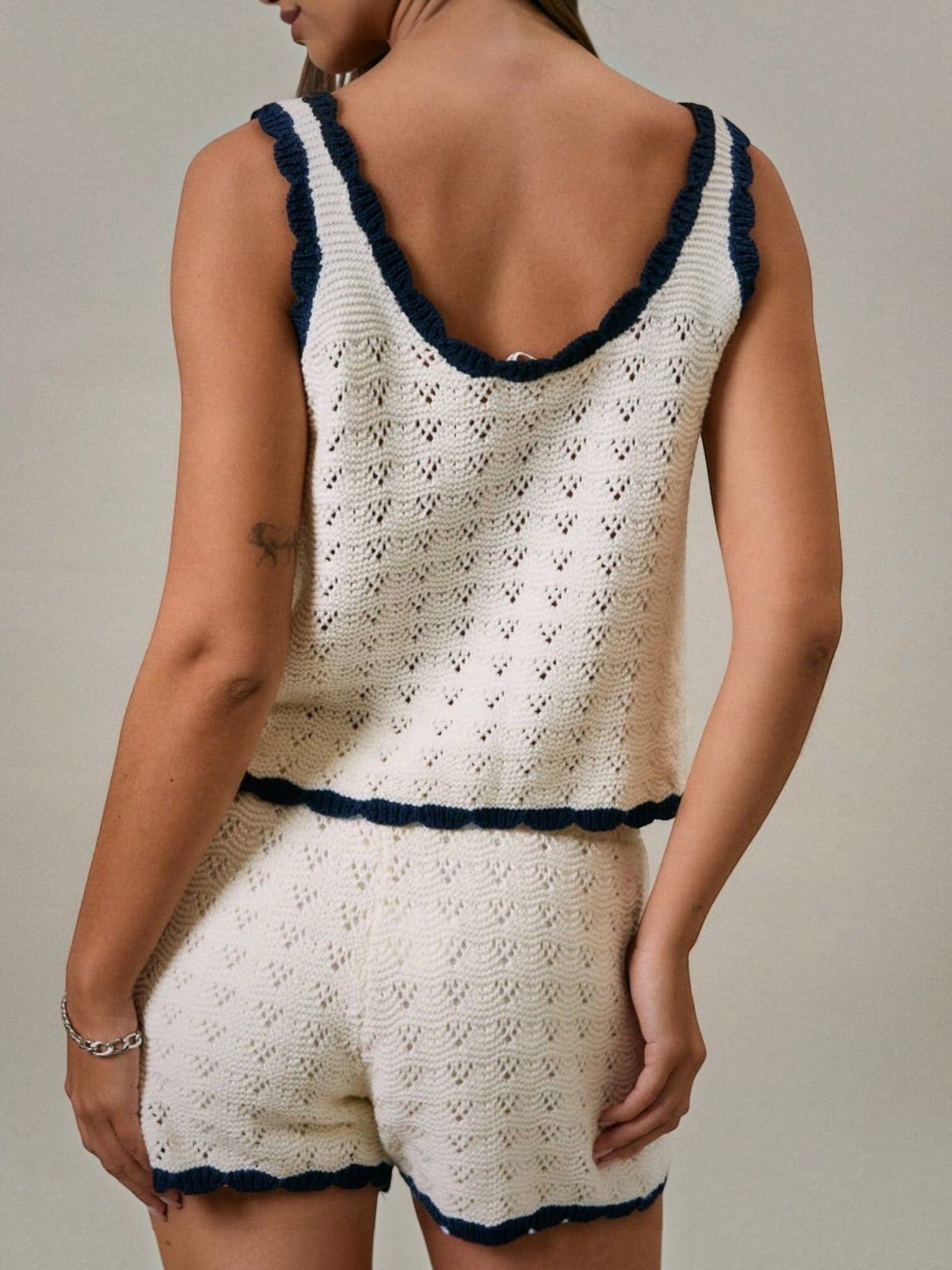 Mialur Harbor knit shorts and matching tank top in cream with navy blue contrast trim, worn by a model from behind.