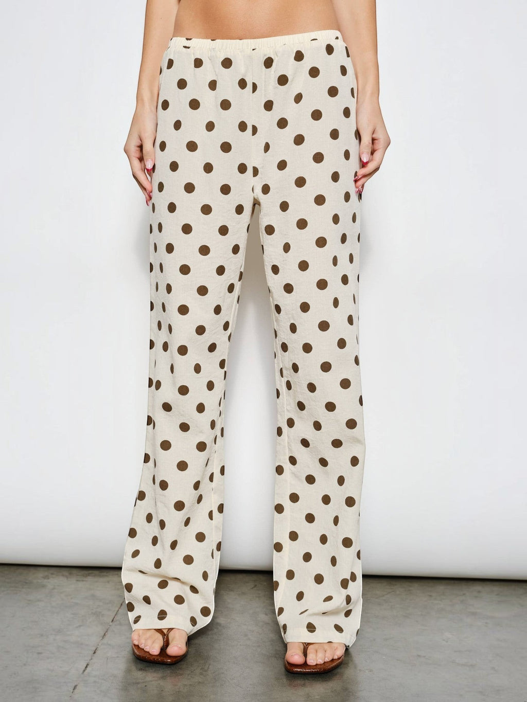Mialur Harper low-rise wide-leg pants in cream with chocolate brown polka dots, featuring an elastic waistband.
