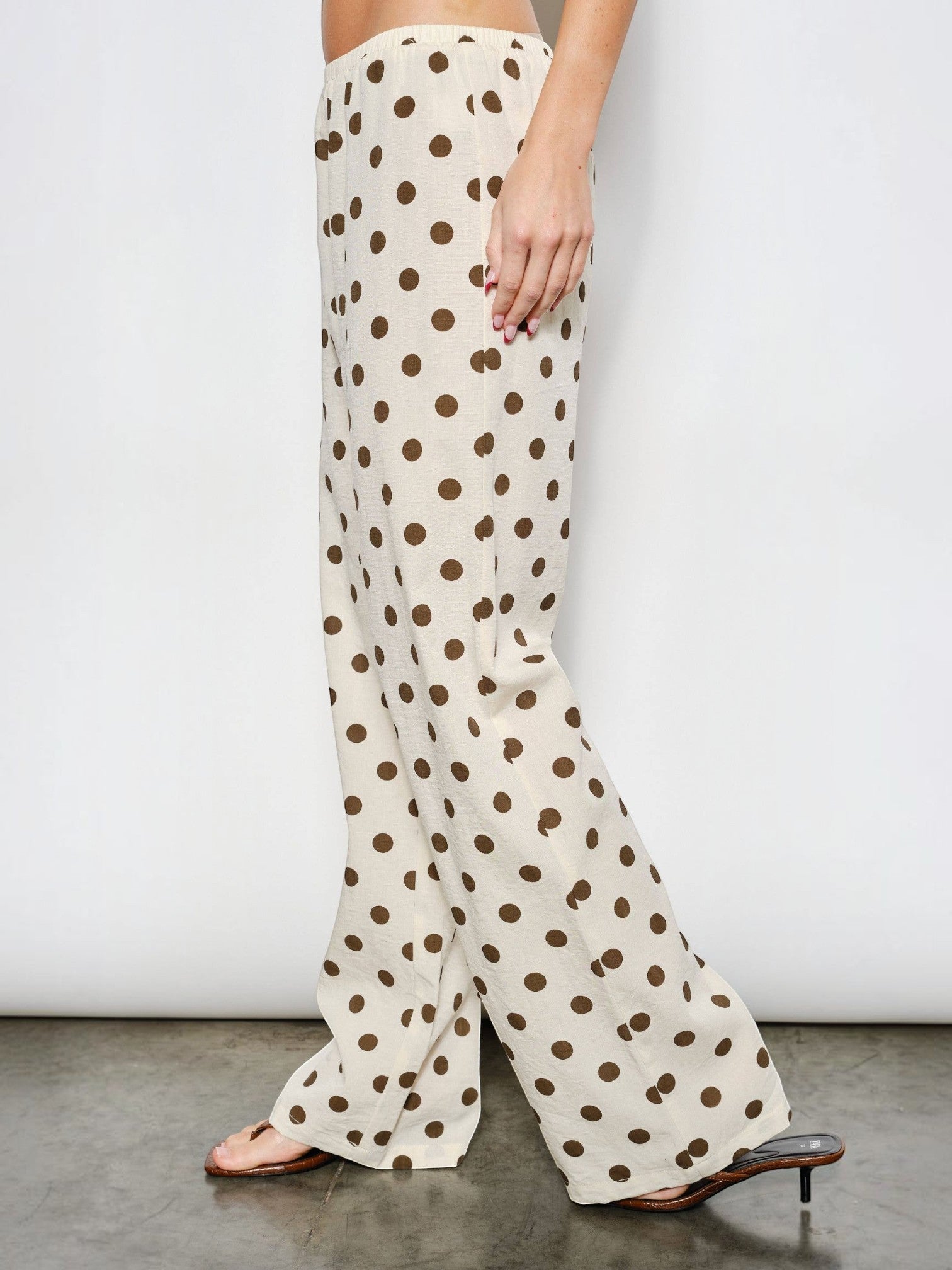 Mialur Harper wide-leg pants in cream with chocolate brown polka dots, featuring an elastic waistband and side pockets.