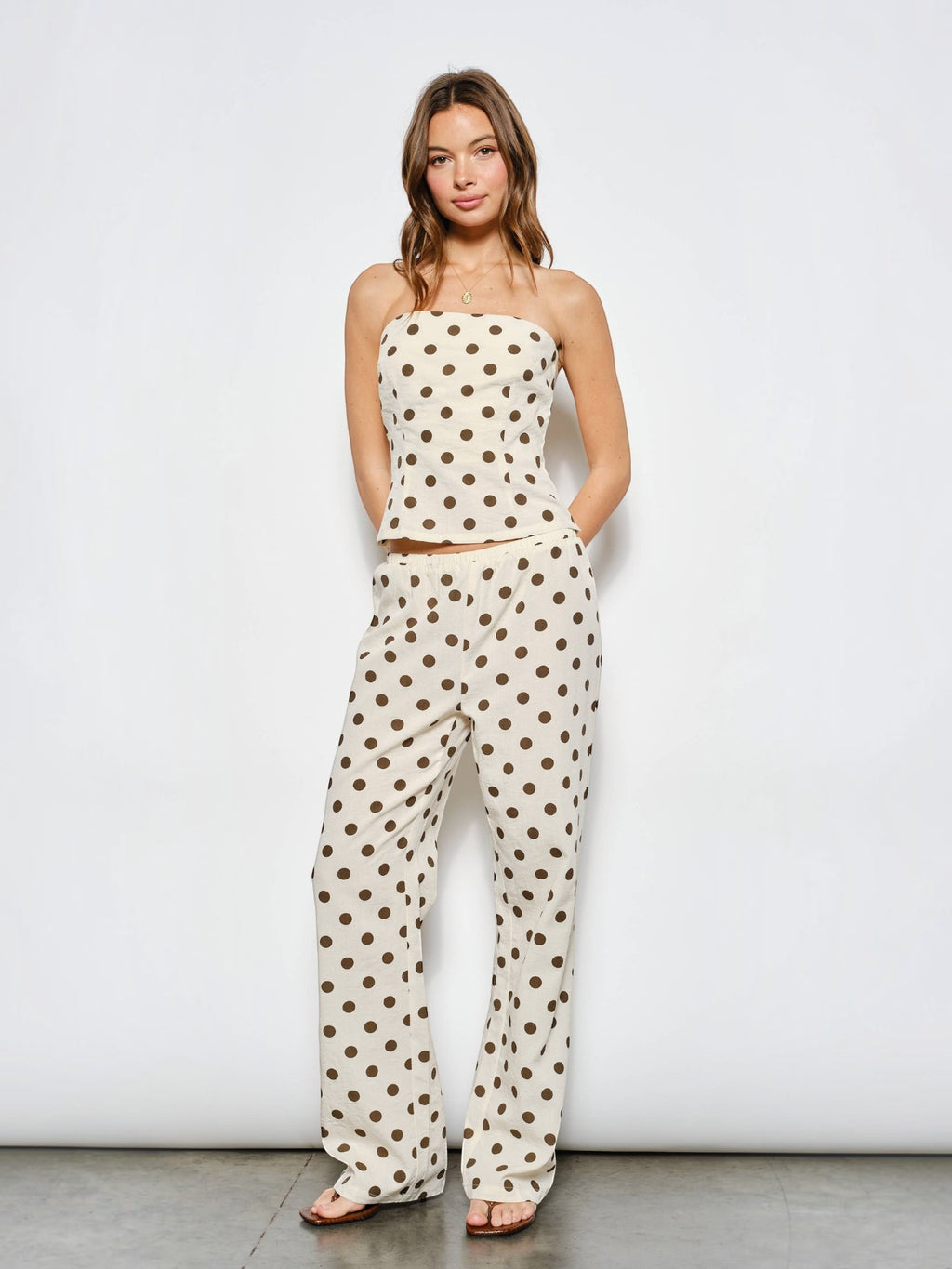 Mialur Harper wide-leg pants in cream with chocolate brown polka dots, worn with matching strapless top