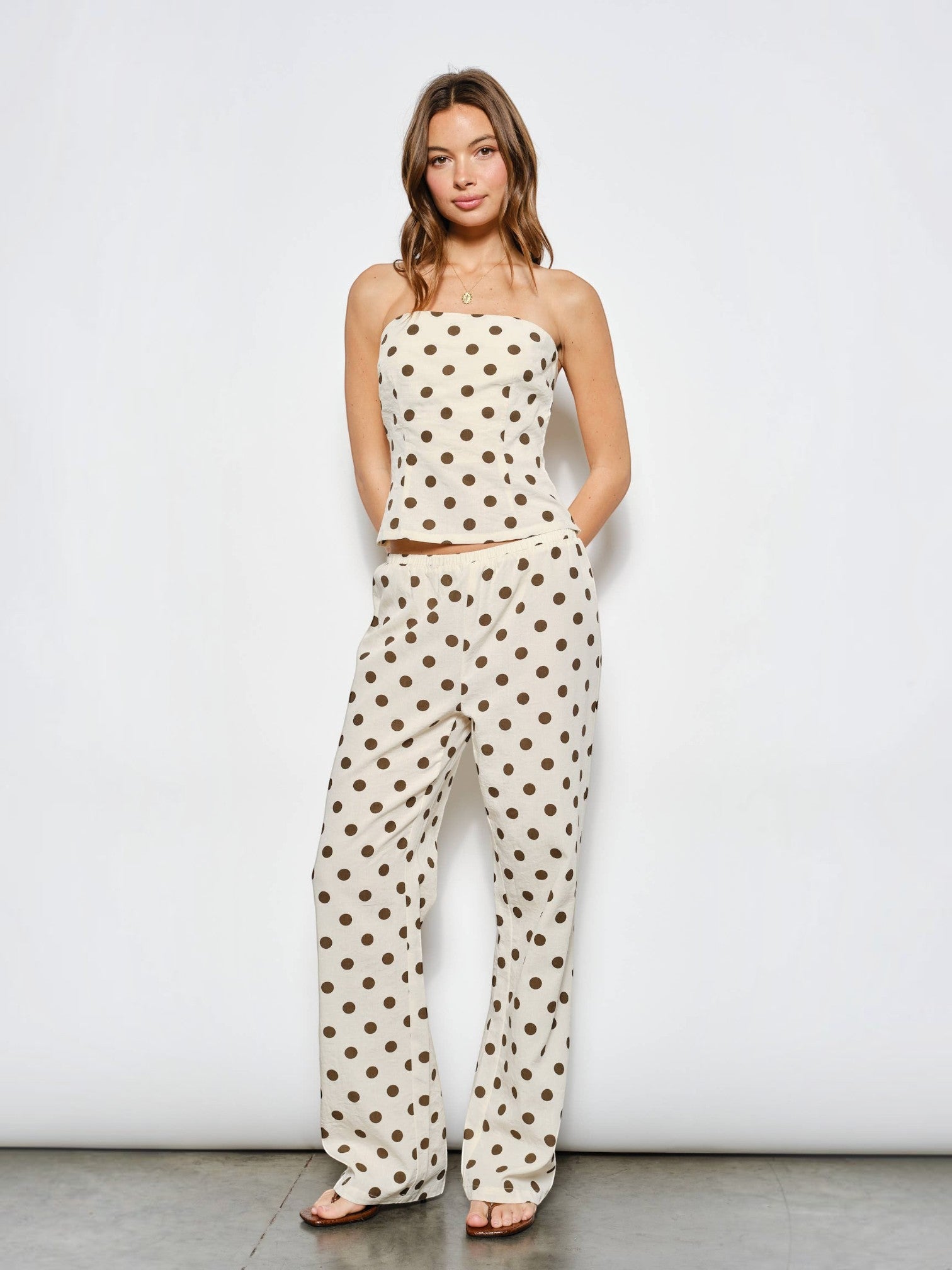 Mialur Harper wide-leg pants in cream with chocolate brown polka dots, worn with matching strapless top