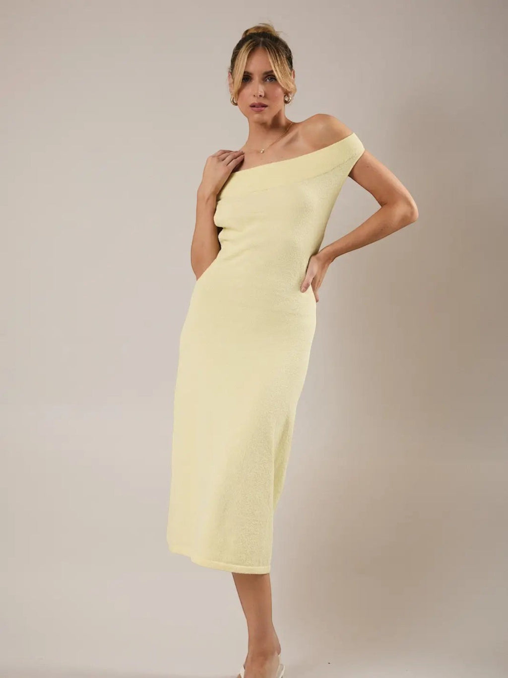 Model wearing a Mialur limoncello yellow off-the-shoulder knit midi dress with a fitted bodice and A-line silhouette.